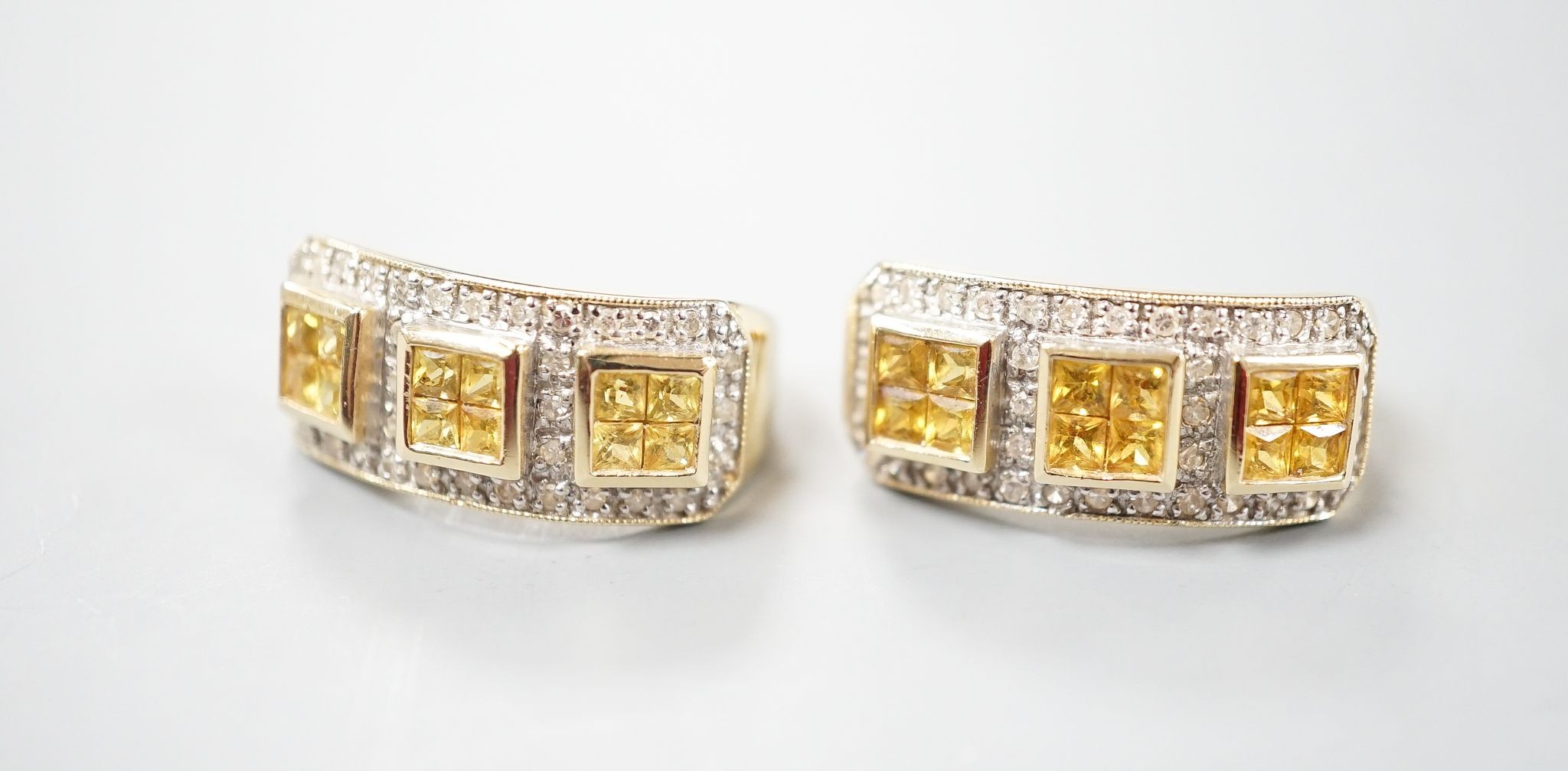 A modern pair of 14k yellow metal, diamond chip and triple cluster yellow sapphire? set half hoop earrings, 19mm, gross weight 6.9 grams.